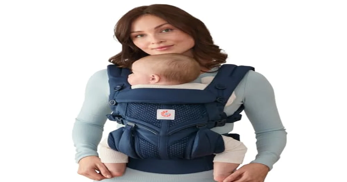 Parent wearing baby in a soft structured carrier outdoors